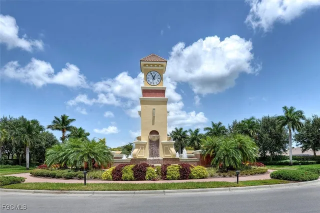a front view of a multi story residential apartment building with yard and parking space
