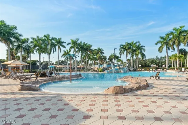 a row of palm trees and swimming pool in the backyard of a house