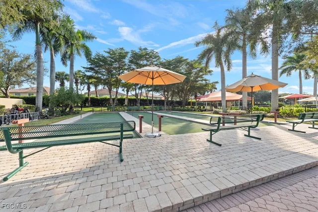 a park view with a swimming pool and wooden fence