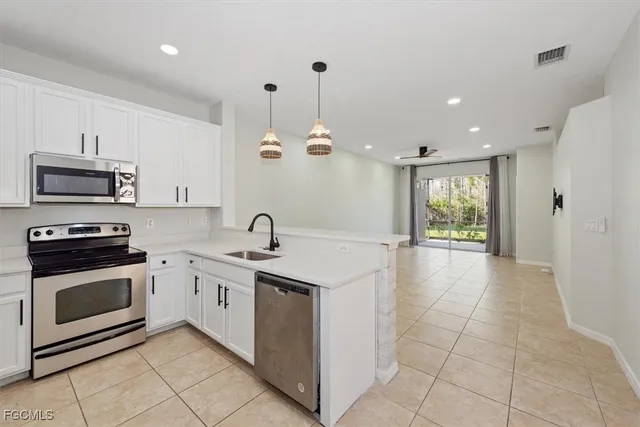 a kitchen with a sink stove and microwave