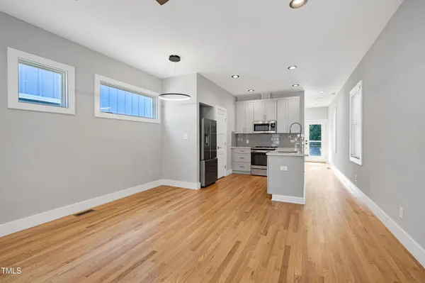 a view of kitchen with microwave and cabinets