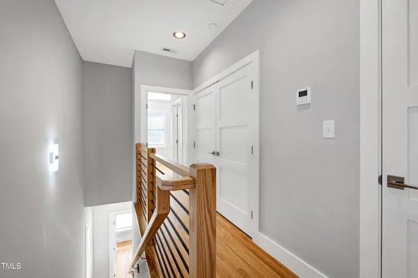 a view of a hallway with wooden floor