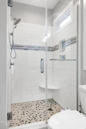 a bathroom with a shower a toilet and sink