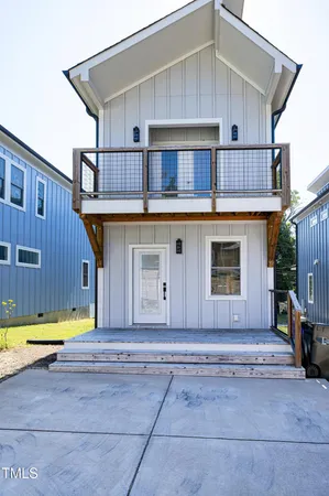 a view of house with backyard and sitting area