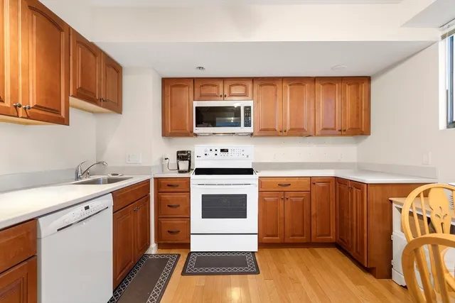 a view of a dining room with furniture a rug and wooden floor