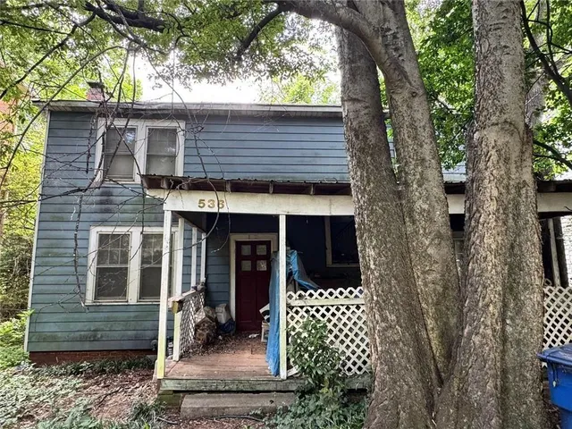 a house view with a tree in the background