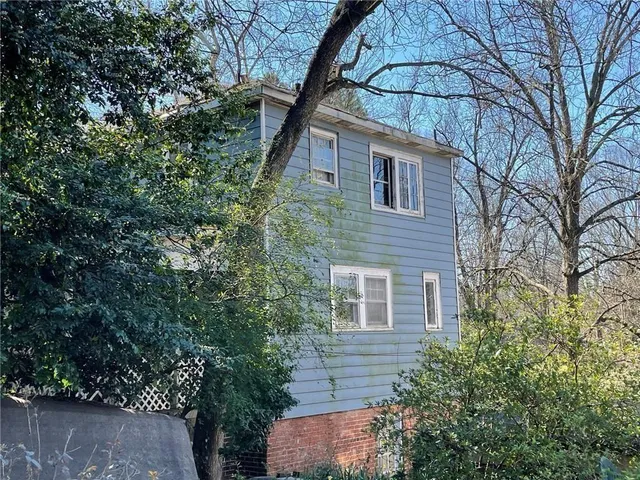 a house that has a tree in front of the house