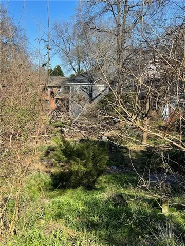 a view of yard with swimming pool and green space