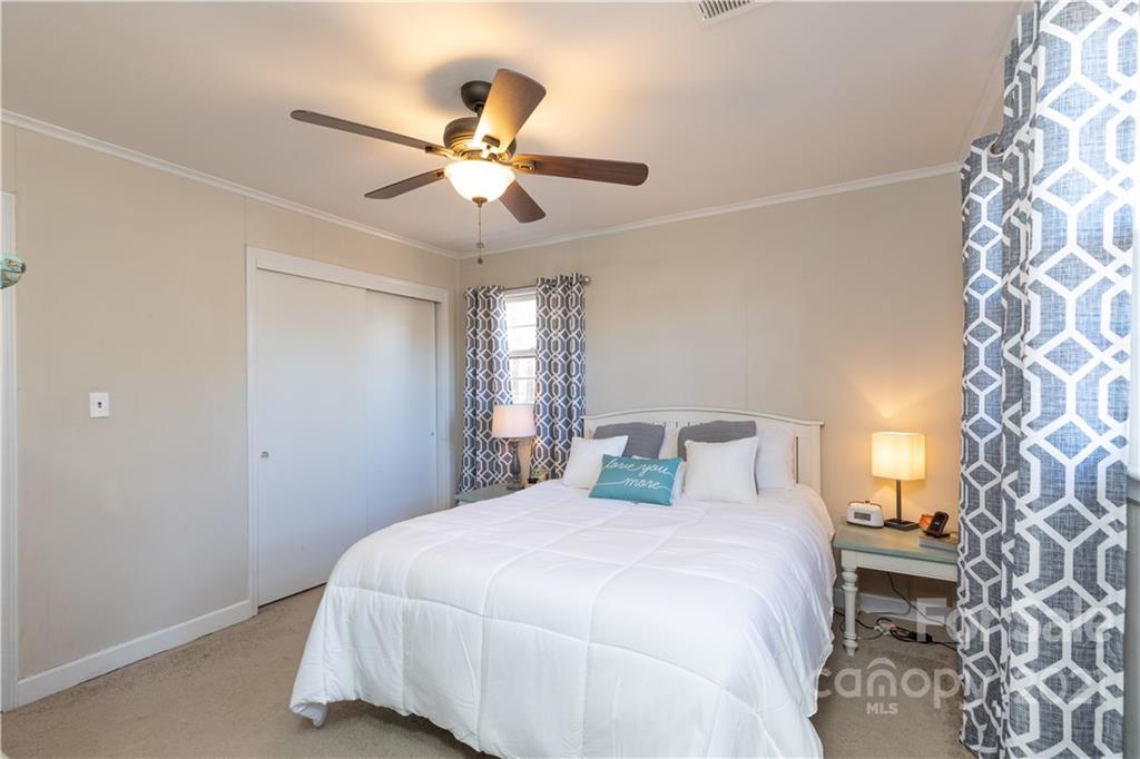 310 West Rambo Road Rock Hill, SC 29730 - Photo 13 of 26 a bedroom with a bed and a chandelier