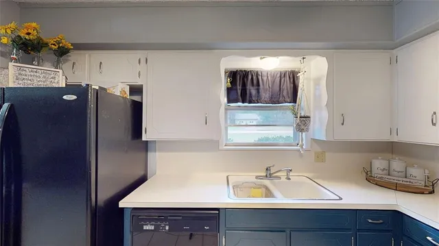 a kitchen with a sink and refrigerator
