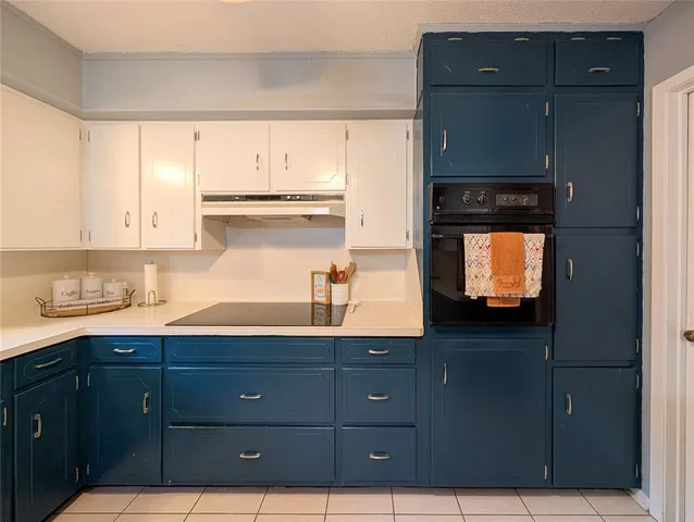 a kitchen with granite countertop wooden cabinets and sink