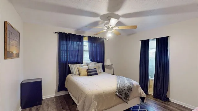 a bedroom with a large bed and a chandelier