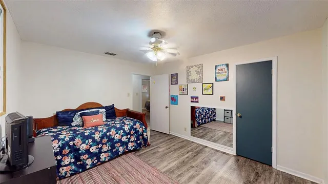 a bedroom with furniture and a chandelier