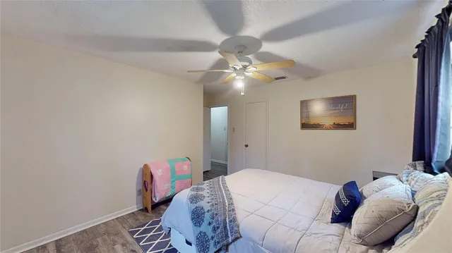 a bedroom with a bed and a chandelier