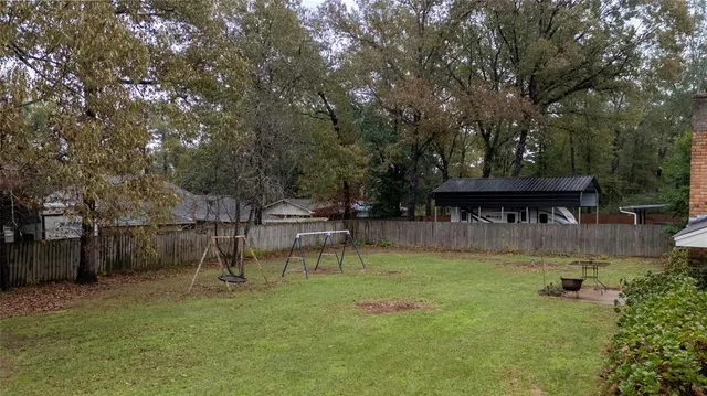 a view of a backyard with a garden and sitting area