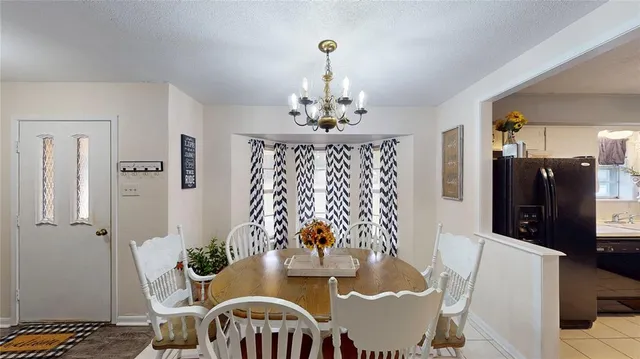 a view of a dining room with furniture and chandelier