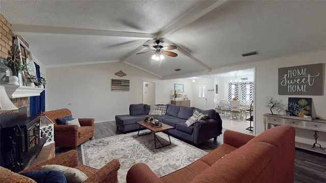 a living room with furniture fireplace and a chandelier