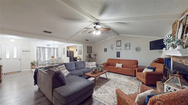 a living room with furniture a ceiling fan and a rug