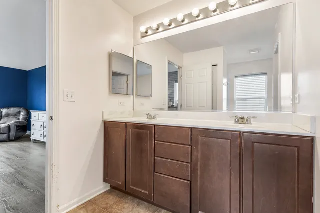 a bathroom with a double vanity sink and a mirror