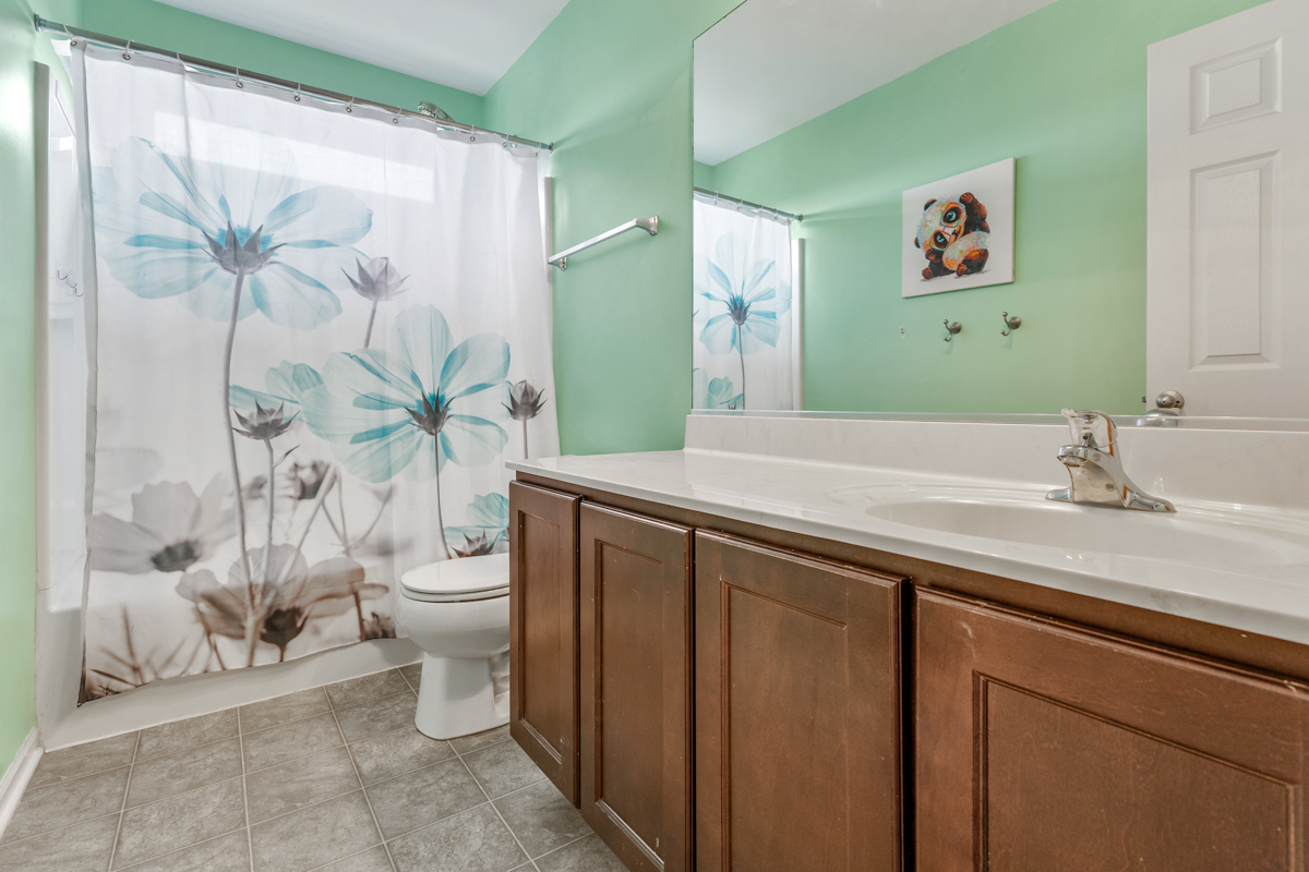 1157 Clearwater Drive Pingree Grove, IL 60140 - Photo 16 of 34 a bathroom with a sink a toilet and a large mirror