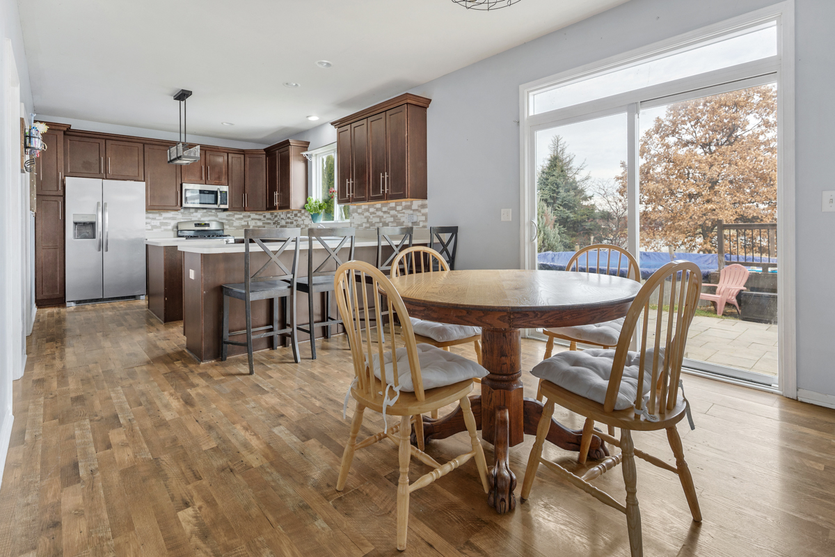 1157 Clearwater Drive Pingree Grove, IL 60140 - Photo 18 of 34 a dining room with furniture and a kitchen view