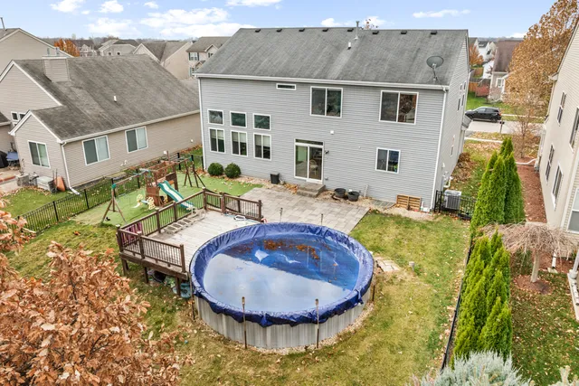 a view of a house with swimming pool and sitting area
