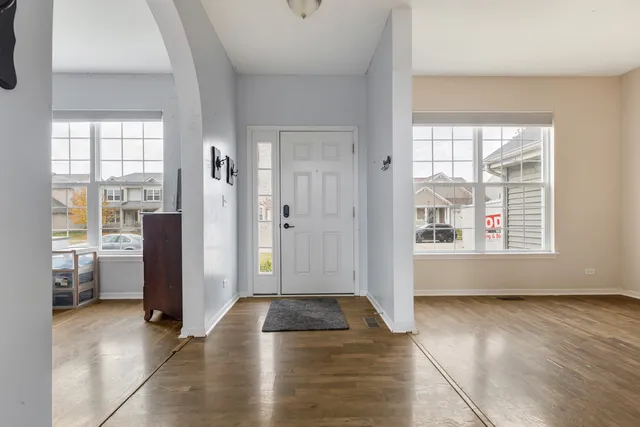a view of a livingroom with wooden floor and windows