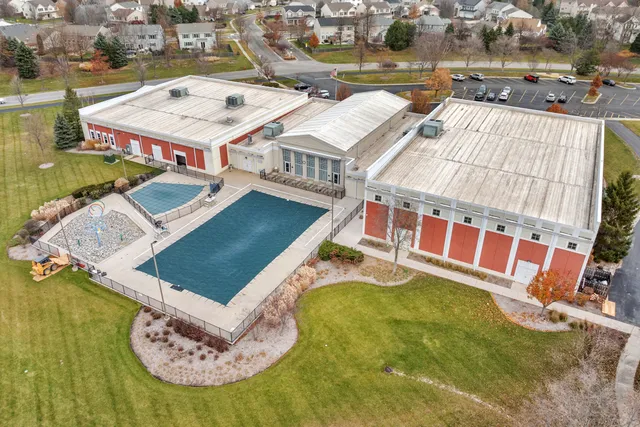 an aerial view of a house with swimming pool and ocean view