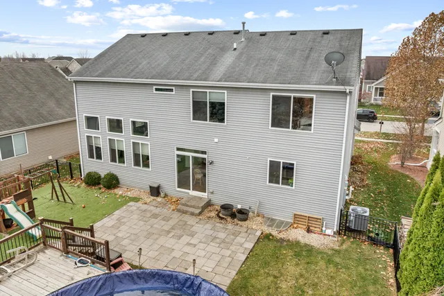 a view of a house with swimming pool and sitting area