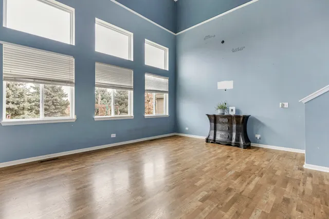 a kitchen with a dining table chairs and cabinets
