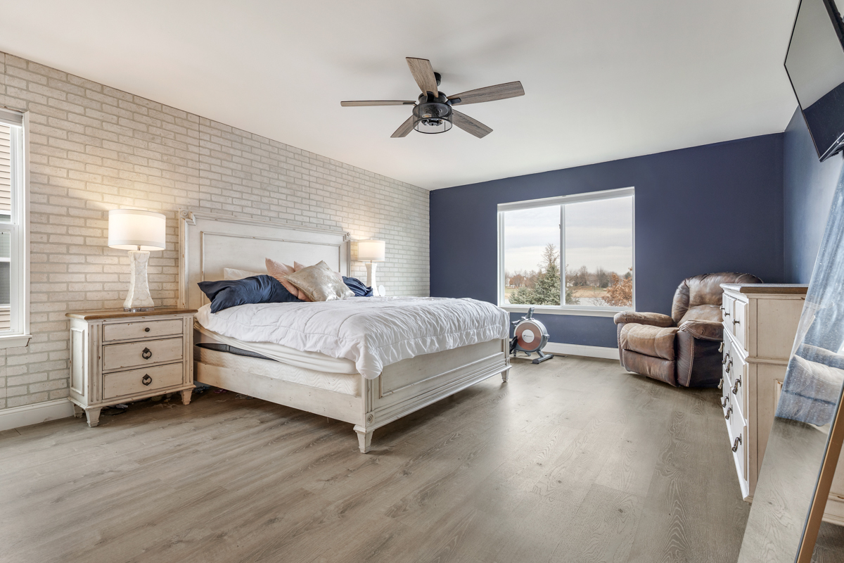 1157 Clearwater Drive Pingree Grove, IL 60140 - Photo 6 of 34 a bedroom with a bed and a couch