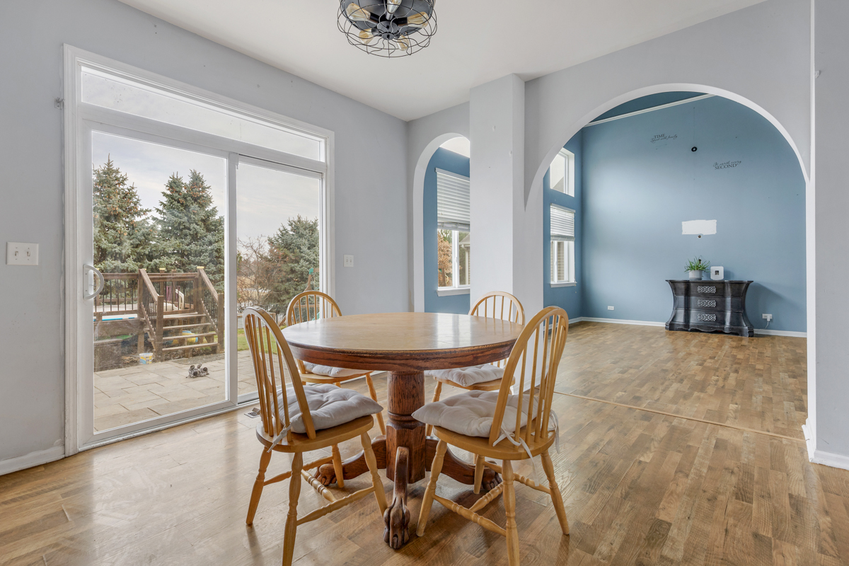 1157 Clearwater Drive Pingree Grove, IL 60140 - Photo 8 of 34 a dining room with furniture and wooden floor