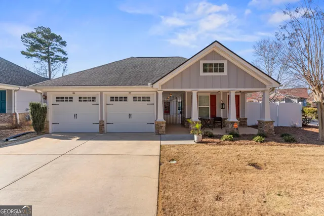 a front view of a house with sitting area and porch