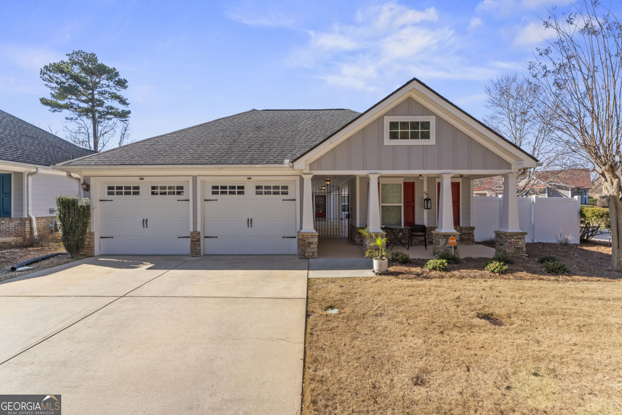 a front view of a house with sitting area and porch