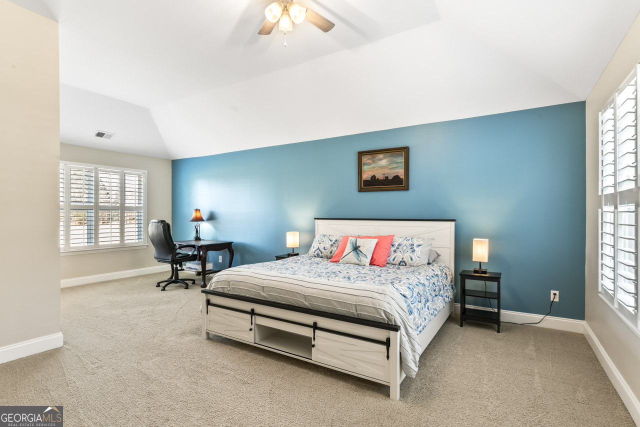 100 Cottage Club Drive Locust Grove, GA 30248 - Photo 16 of 42 a bedroom with a bed and a table in it with window