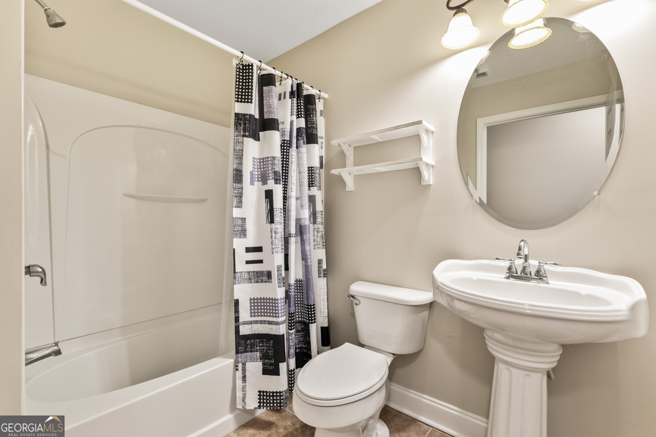 100 Cottage Club Drive Locust Grove, GA 30248 - Photo 21 of 42 a bathroom with a sink toilet and shower