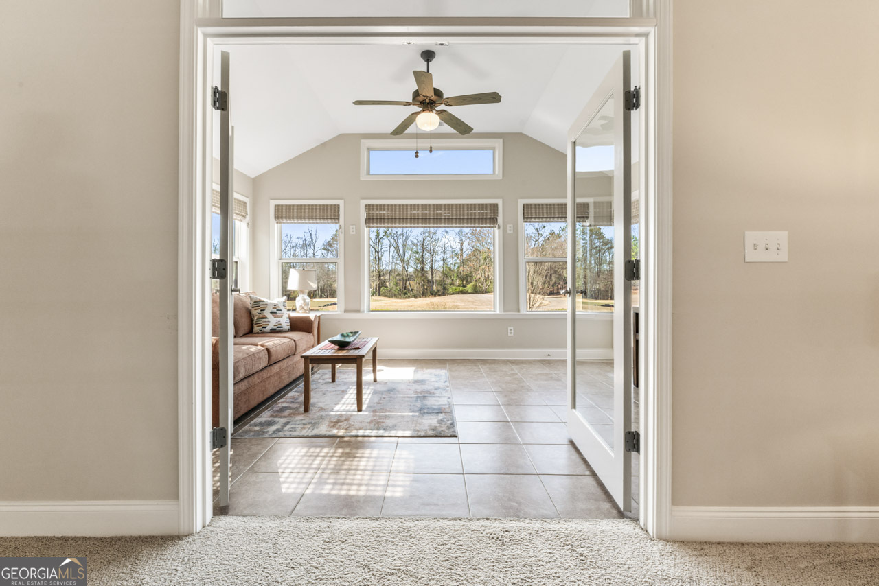 100 Cottage Club Drive Locust Grove, GA 30248 - Photo 22 of 42 a living room with furniture and a large window