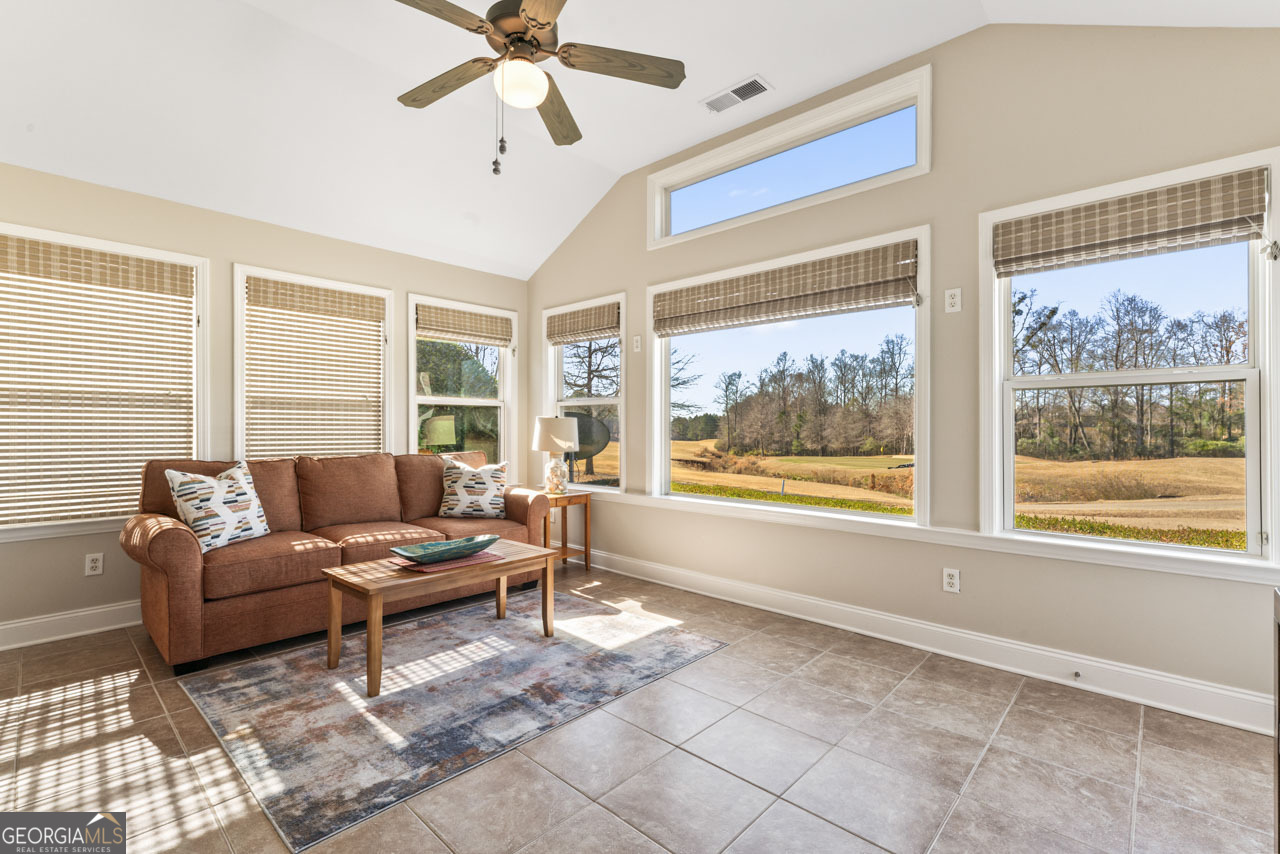 100 Cottage Club Drive Locust Grove, GA 30248 - Photo 23 of 42 a living room with furniture and large windows