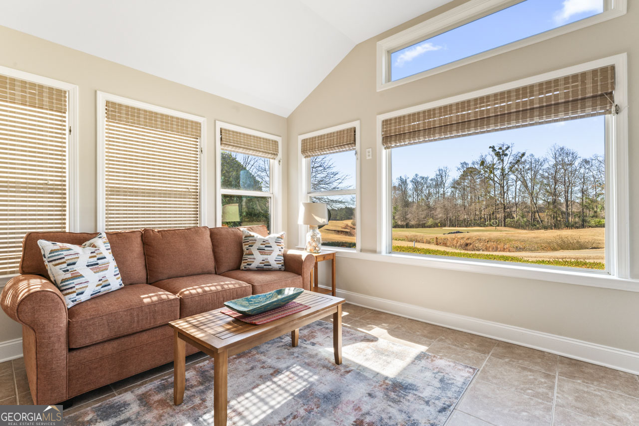 100 Cottage Club Drive Locust Grove, GA 30248 - Photo 24 of 42 a living room with furniture and a large window
