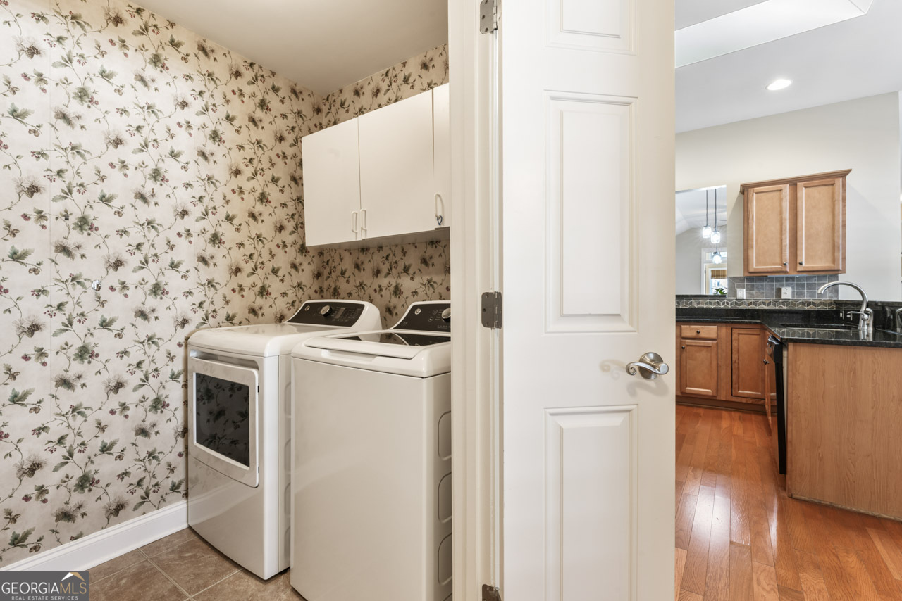 100 Cottage Club Drive Locust Grove, GA 30248 - Photo 26 of 42 a view of a kitchen with a sink and a stove top oven