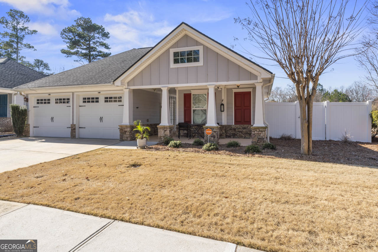 100 Cottage Club Drive Locust Grove, GA 30248 - Photo 3 of 42 a front view of a house with a yard