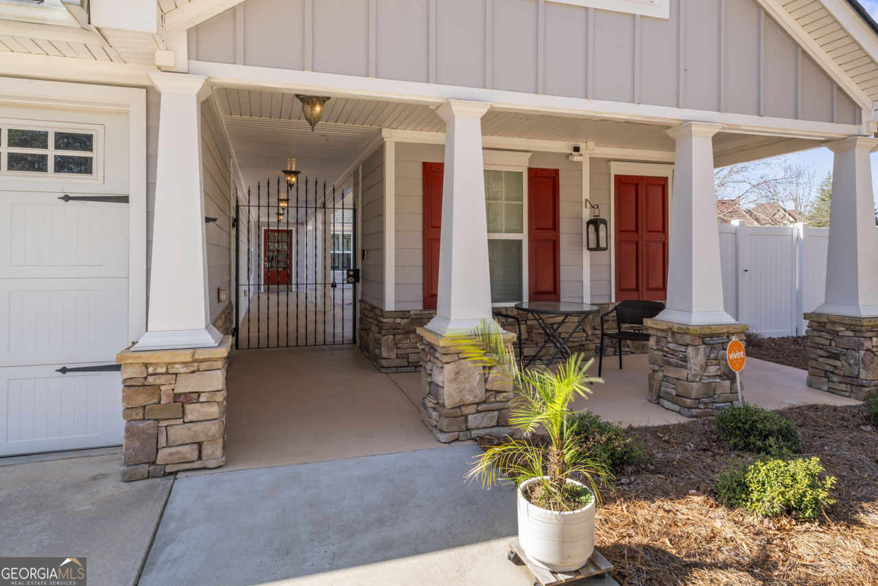 100 Cottage Club Drive Locust Grove, GA 30248 - Photo 4 of 42 a front view of a house with outdoor seating