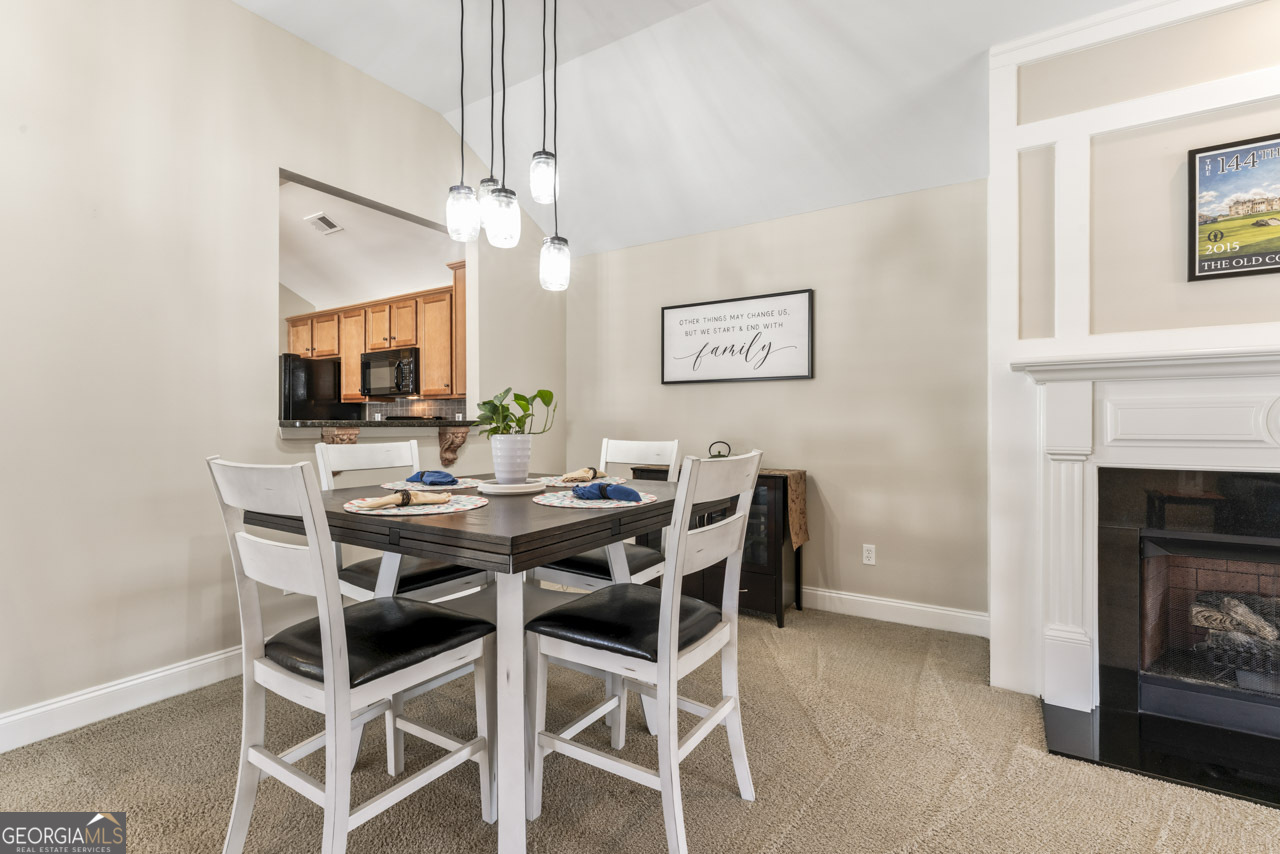 100 Cottage Club Drive Locust Grove, GA 30248 - Photo 6 of 42 a view of a dining room with furniture and wooden floor