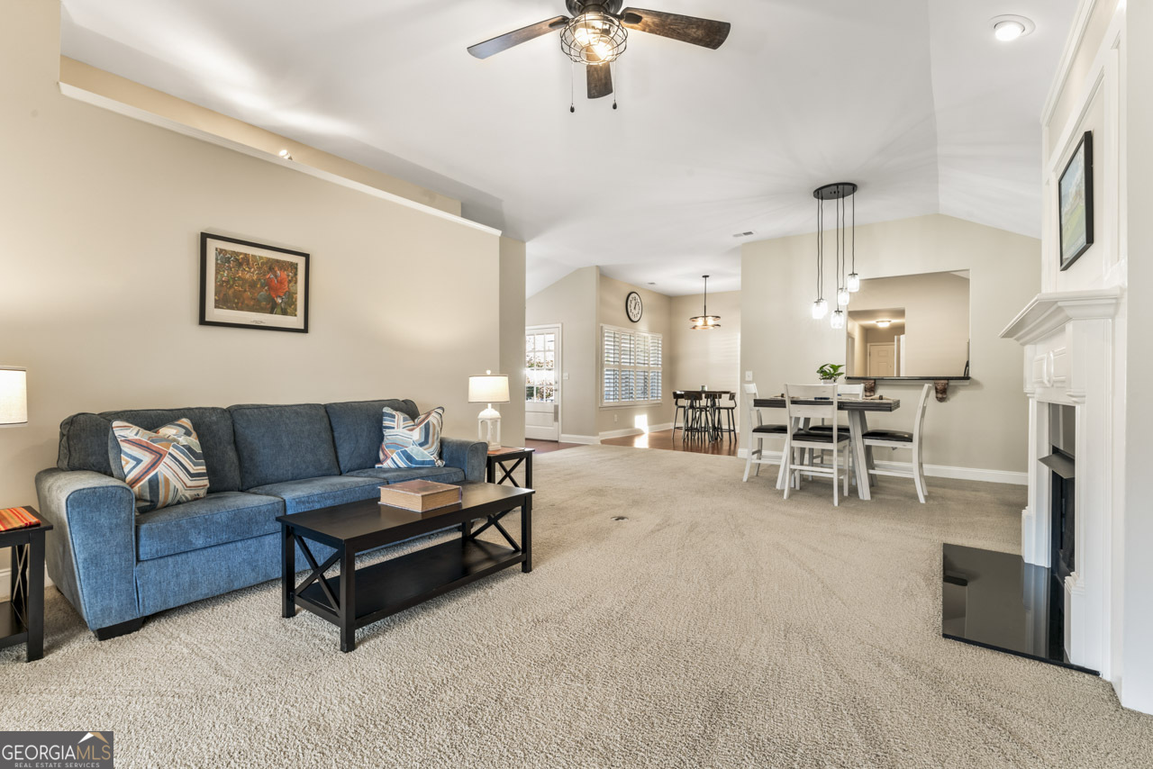 100 Cottage Club Drive Locust Grove, GA 30248 - Photo 8 of 42 a living room with furniture and a chandelier