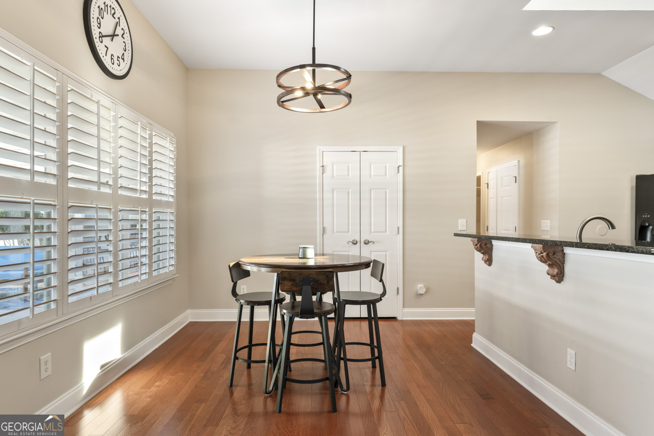 100 Cottage Club Drive Locust Grove, GA 30248 - Photo 10 of 42 a view of a dining room with furniture window and wooden floor