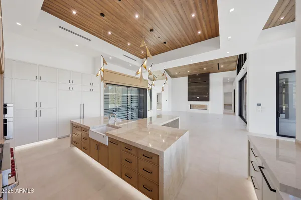 a kitchen that has a lot of cabinets and wooden floor