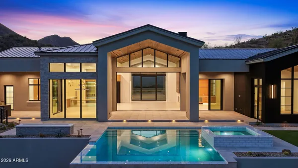 a view of a big house with a mountain in the background