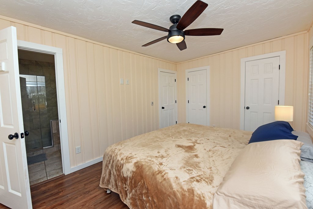 16894 Morganton Highway Morganton, GA 30560 - Photo 24 of 51 a bedroom with a bed and a ceiling fan
