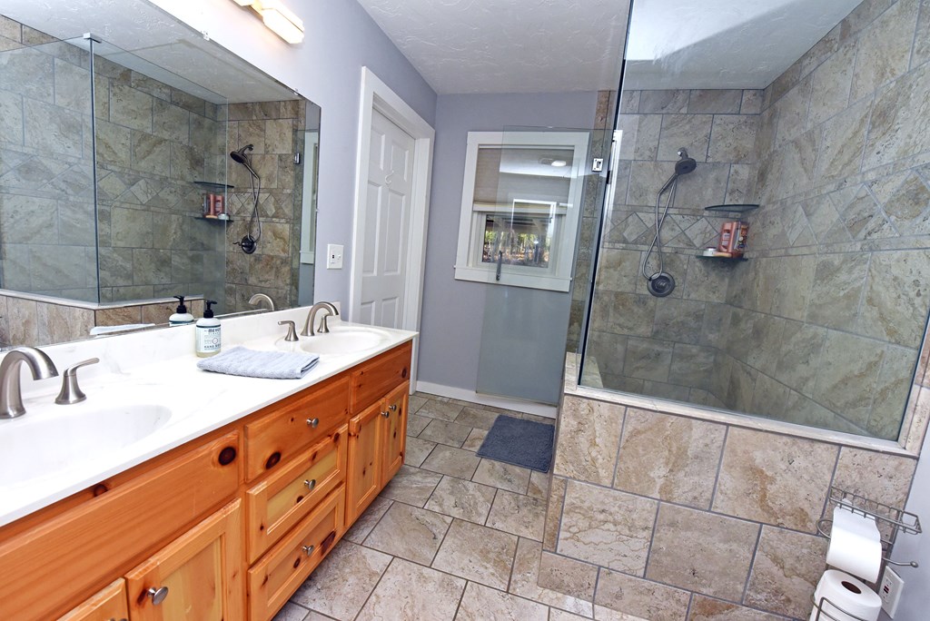 16894 Morganton Highway Morganton, GA 30560 - Photo 26 of 51 a bathroom with a double vanity sink mirror and shower