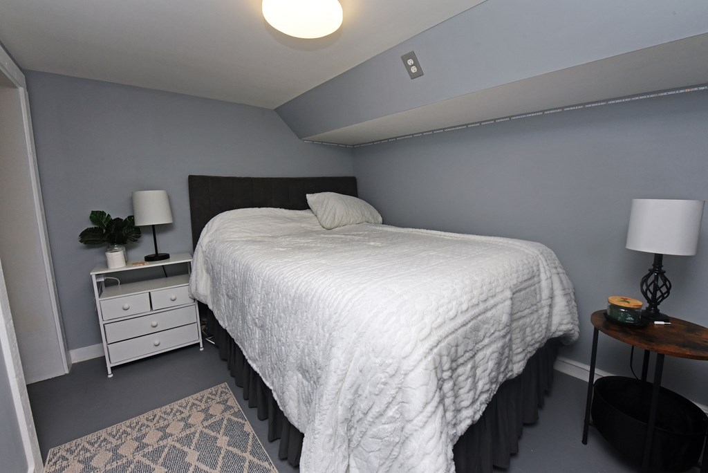 16894 Morganton Highway Morganton, GA 30560 - Photo 30 of 51 a large bed sitting in a bedroom next to a lamp